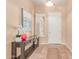 Warm foyer featuring tile flooring, decorative console table, and sunlit window, creating an inviting entry space at 20283 N 273Rd Ave, Buckeye, AZ 85396