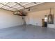 Spacious two-car garage with high ceilings and ample storage shelves at 20283 N 273Rd Ave, Buckeye, AZ 85396
