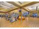 The gym features lots of exercise machines and equipment on a wooden floor with yellow walls and multiple televisions at 20283 N 273Rd Ave, Buckeye, AZ 85396