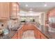 Spacious kitchen with stainless steel appliances, granite counters, and island at 20283 N 273Rd Ave, Buckeye, AZ 85396