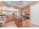 Well appointed kitchen features stainless appliances, granite countertops, and a kitchen island at 20283 N 273Rd Ave, Buckeye, AZ 85396