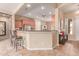 Well-lit kitchen features stainless appliances, breakfast bar, and tile floors at 20283 N 273Rd Ave, Buckeye, AZ 85396