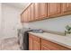 Laundry room featuring washer, dryer, built in cabinets and counter space at 20283 N 273Rd Ave, Buckeye, AZ 85396