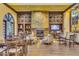 Comfortable lounge area featuring a stone fireplace, wood built-ins, soft seating, and a large window for natural light at 20283 N 273Rd Ave, Buckeye, AZ 85396