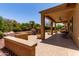 Large covered patio with beautiful lush backyard and outdoor furniture at 20283 N 273Rd Ave, Buckeye, AZ 85396