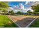 Outdoor volleyball court surrounded by green grass, trees and blue skies with a net stretched across the center at 20283 N 273Rd Ave, Buckeye, AZ 85396