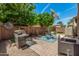 Backyard with stainless steel grill and outdoor seating on brick patio, perfect for entertaining at 2048 S Martingale Rd, Gilbert, AZ 85295