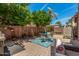 Charming backyard featuring a brick patio, lush greenery, and cozy outdoor seating at 2048 S Martingale Rd, Gilbert, AZ 85295
