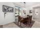 Charming dining area featuring a wooden table set, stylish rug, and abundant natural light from the sliding glass doors at 2048 S Martingale Rd, Gilbert, AZ 85295