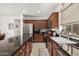 Modern kitchen boasting stainless steel appliances, dark countertops, and ample cabinet space at 2048 S Martingale Rd, Gilbert, AZ 85295