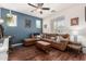 Cozy living area showcasing a brown sectional sofa with plush pillows and wood-look flooring at 2048 S Martingale Rd, Gilbert, AZ 85295