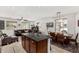 Open-concept living area with kitchen island, dining space, and comfortable seating arrangement at 2048 S Martingale Rd, Gilbert, AZ 85295