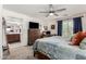 Cozy main bedroom with a ceiling fan, desk, and ensuite bath, offering a private and functional retreat at 2048 S Martingale Rd, Gilbert, AZ 85295