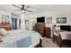 Bright bedroom featuring a ceiling fan, plenty of space and storage, as well as an ensuite bath at 2048 S Martingale Rd, Gilbert, AZ 85295