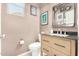 This powder room boasts a modern vanity, elegant mirror, and stylish fixtures, offering a blend of comfort and sophistication at 2048 S Martingale Rd, Gilbert, AZ 85295