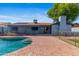 Serene backyard featuring a pristine pool, brick patio, and private outdoor space at 2114 E Sesame St, Tempe, AZ 85283