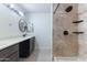 Updated bathroom featuring double sinks, quartz countertops, and a shower with rainfall showerhead at 2114 E Sesame St, Tempe, AZ 85283