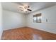 Spacious bedroom with wood laminate flooring, ceiling fan, and a large window at 2114 E Sesame St, Tempe, AZ 85283
