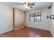 Bedroom with laminate floors, ceiling fan, a window and a wood Murphy bed at 2114 E Sesame St, Tempe, AZ 85283