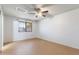 Well-lit room with a window, a ceiling fan, and wood-look flooring throughout at 2114 E Sesame St, Tempe, AZ 85283