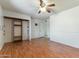 Large bedroom with laminate wood flooring, ceiling fan and closet space at 2114 E Sesame St, Tempe, AZ 85283