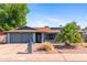 Inviting home exterior showcasing a well-manicured yard, desert landscaping, and a cozy entrance at 2114 E Sesame St, Tempe, AZ 85283