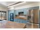 Modern kitchen featuring stainless steel appliances, blue cabinets, and granite countertops at 2114 E Sesame St, Tempe, AZ 85283