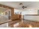 Spacious living room with hardwood flooring, sliding glass doors to the backyard, and views of the kitchen at 2114 E Sesame St, Tempe, AZ 85283