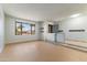 Bright, open living room with tile entryway, wood flooring, and a large window overlooking the front yard at 2114 E Sesame St, Tempe, AZ 85283