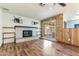 Cozy living room with hardwood floors, a brick fireplace, and sliding glass doors to the backyard at 2114 E Sesame St, Tempe, AZ 85283