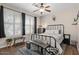 Cozy bedroom with a metal bed frame, wood floors and plantation shutters at 22634 N 47Th Pl, Phoenix, AZ 85050