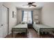 Bedroom displaying twin beds, wood-look floors, and a ceiling fan at 22634 N 47Th Pl, Phoenix, AZ 85050