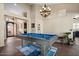 Bright game room with a pool table, tile floors, neutral walls, and decorative lighting at 22634 N 47Th Pl, Phoenix, AZ 85050