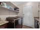 Laundry room equipped with washer, dryer, shelving, and storage space at 22634 N 47Th Pl, Phoenix, AZ 85050