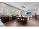 Bright open-concept living area with kitchen island, tile floors, and media center at 22634 N 47Th Pl, Phoenix, AZ 85050