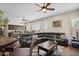 Open-concept living room with dark leather furniture and a view into the kitchen at 22634 N 47Th Pl, Phoenix, AZ 85050