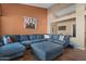 Living room featuring a large sectional sofa and decorative accents in a modern home at 22634 N 47Th Pl, Phoenix, AZ 85050