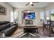 Cozy living room featuring a black leather couch, recessed media center and shuttered windows at 22634 N 47Th Pl, Phoenix, AZ 85050
