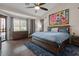Bright bedroom features wooden floors, a large bed and an abundance of light at 22634 N 47Th Pl, Phoenix, AZ 85050