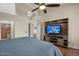 Bright bedroom features wooden floors, a large bed, ceiling fan and ensuite bathroom at 22634 N 47Th Pl, Phoenix, AZ 85050