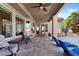 Covered patio with tile flooring, ceiling fan, lounge chairs and outdoor grill at 22634 N 47Th Pl, Phoenix, AZ 85050