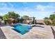 Backyard oasis features a sparkling pool, spa, and lush landscaping at 22634 N 47Th Pl, Phoenix, AZ 85050