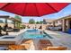 Pool deck with lounge chairs, a pool with spa, and an umbrella at 22634 N 47Th Pl, Phoenix, AZ 85050