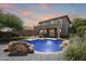 Inviting backyard with a sparkling pool, lush landscaping, and a two-story home in the background at 2762 E Clifton Ave, Gilbert, AZ 85295