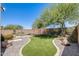Private backyard features manicured lawn, rock features, mature landscaping, and fenced pool area at 2762 E Clifton Ave, Gilbert, AZ 85295