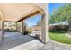 Relaxing backyard featuring a covered patio, lush green lawn, and a tranquil rock pool at 2762 E Clifton Ave, Gilbert, AZ 85295