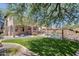 Spacious backyard, lush artificial turf, a rock pool, and a covered patio for outdoor entertaining at 2762 E Clifton Ave, Gilbert, AZ 85295