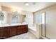 Bright bathroom featuring double vanity, soaking tub, and glass-enclosed shower at 2762 E Clifton Ave, Gilbert, AZ 85295