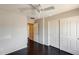 This bedroom has a large closet, wood floors, and a ceiling fan at 2762 E Clifton Ave, Gilbert, AZ 85295
