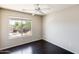 This bedroom has a ceiling fan and a window view of the neighborhood at 2762 E Clifton Ave, Gilbert, AZ 85295